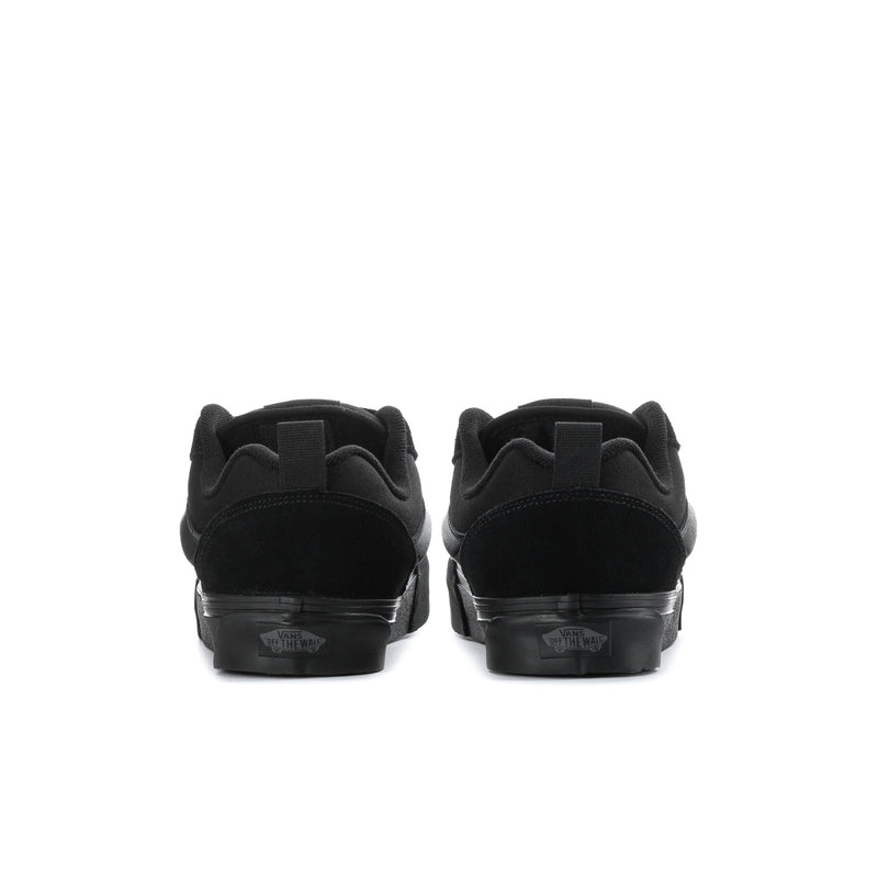 Back view of black low-top sneakers with heel tab and rubber sole