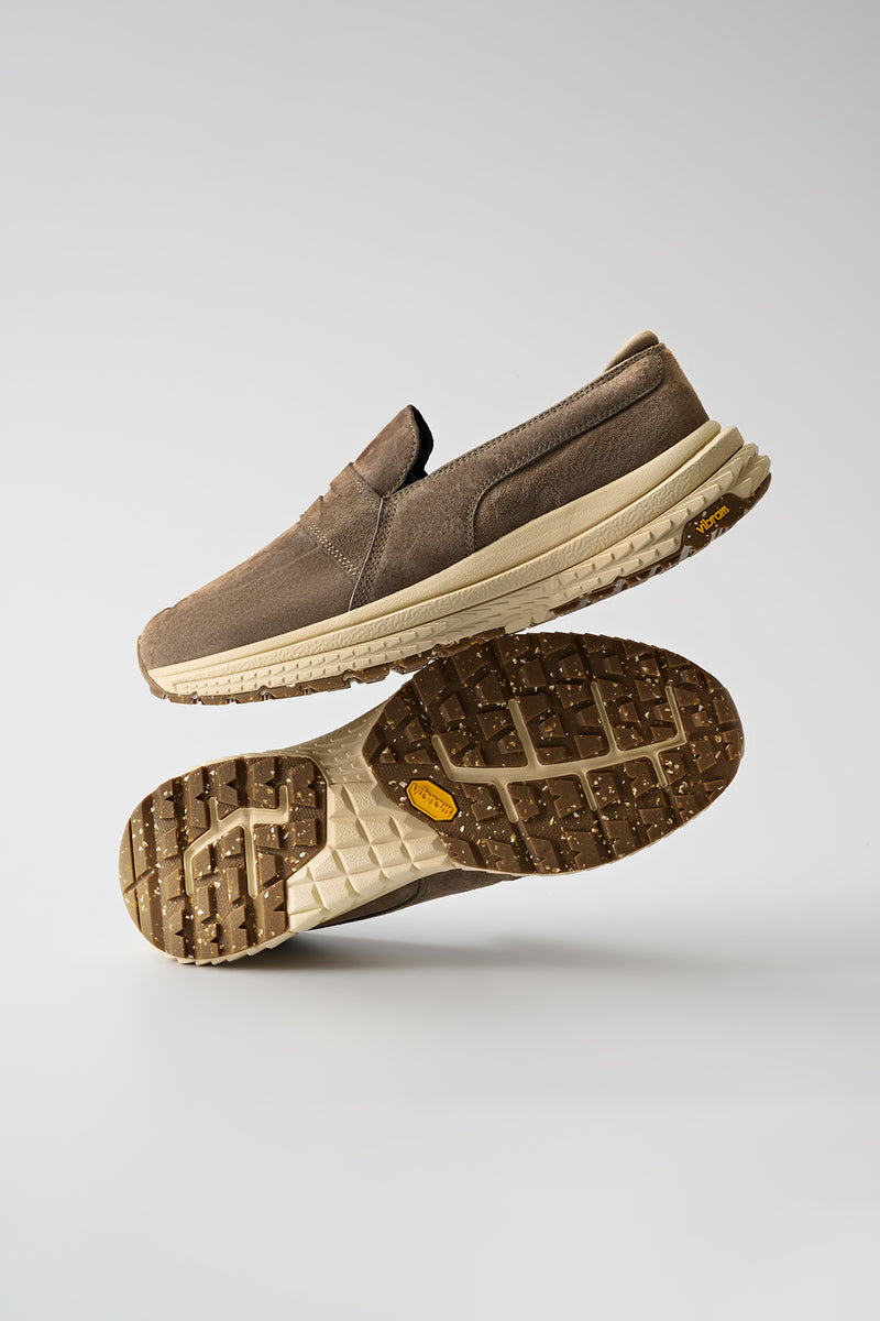 Side view of the Liaizon Vibram Walnut suede loafer on a stacked beige Vibram sole