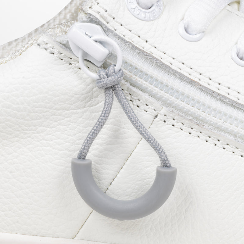 Light Grey loop zipper pull attached to a white sneaker