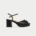 Black platform sandal on a light gray background