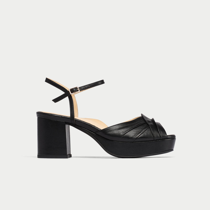 Black platform sandal on a light gray background