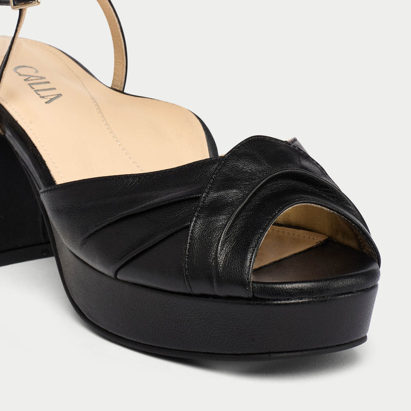 Black platform sandal on a white background