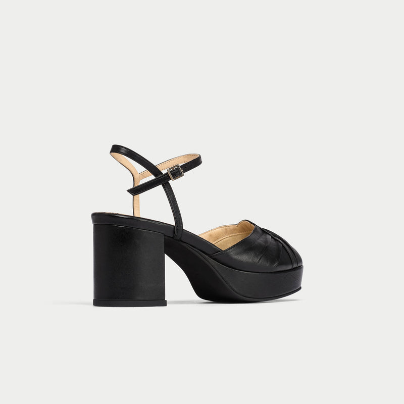 Black high-heeled sandal on a light gray background