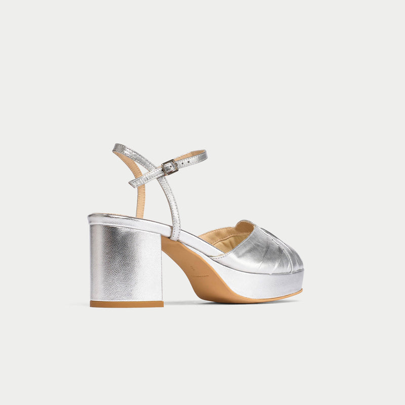 Silver high-heeled sandal on a white background