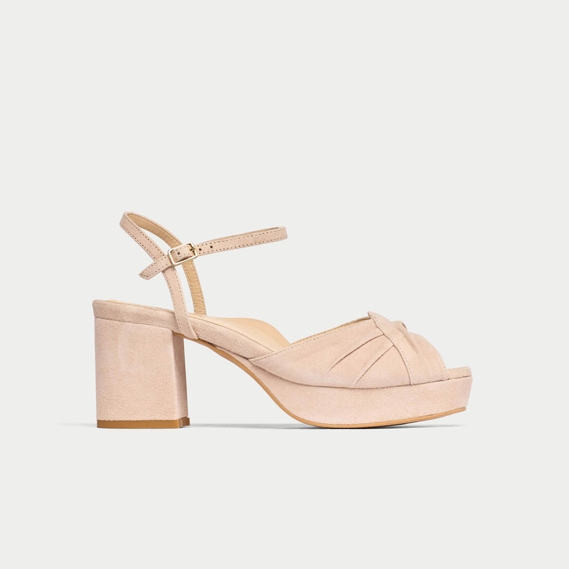 Beige sandal with block heel on a light gray background