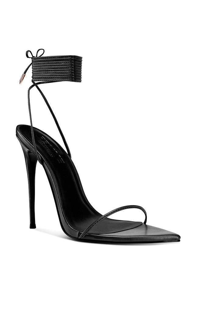 FEMME LA Luce Minimale black stiletto sandal — front three-quarter view showing pointed toe, thin toe strap, and lace-up ankle wrap with gold aglets