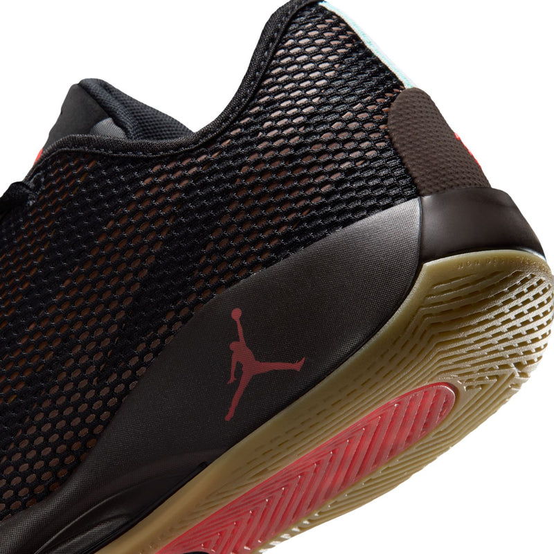Close-up of men's black basketball shoe heel with red logo and brown textured outsole