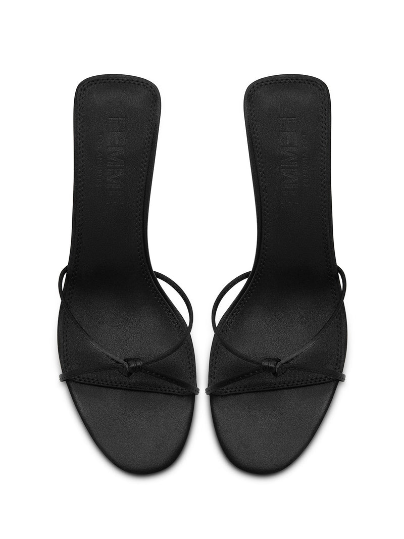 FEMME LA black satin Maeve Slipper mules, overhead flat lay showing FEMME embossed insoles and knot strap detail
