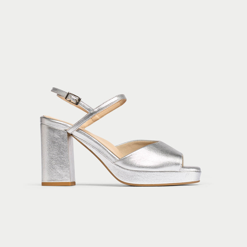 Silver high-heeled sandal on a light gray background
