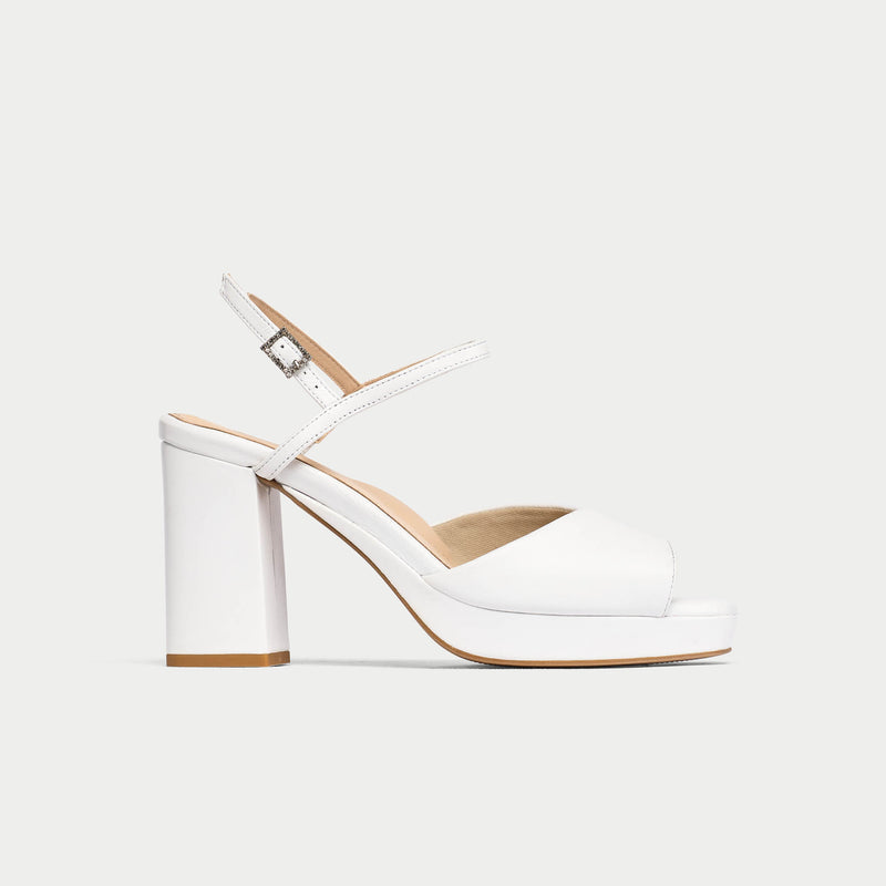 White high-heeled shoe with a block heel on a light gray background