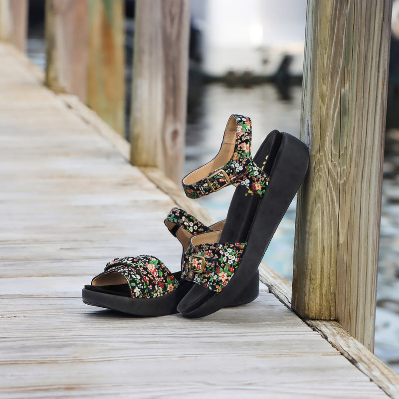 Ladylike charm defines this Maryn leather sandal with adjustable hook-and-loop straps at the vamp and instep that's trimmed with decorative buckles.X