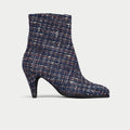 Navy blue tweed ankle boot on a light gray background