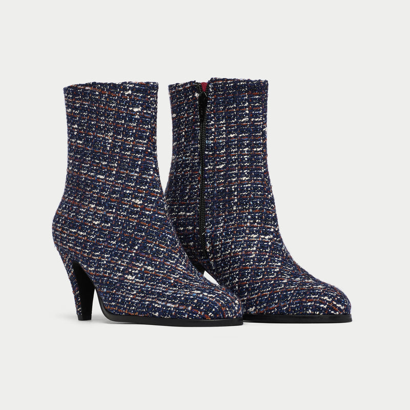 Pair of Maya tweed ankle boots on a light gray background