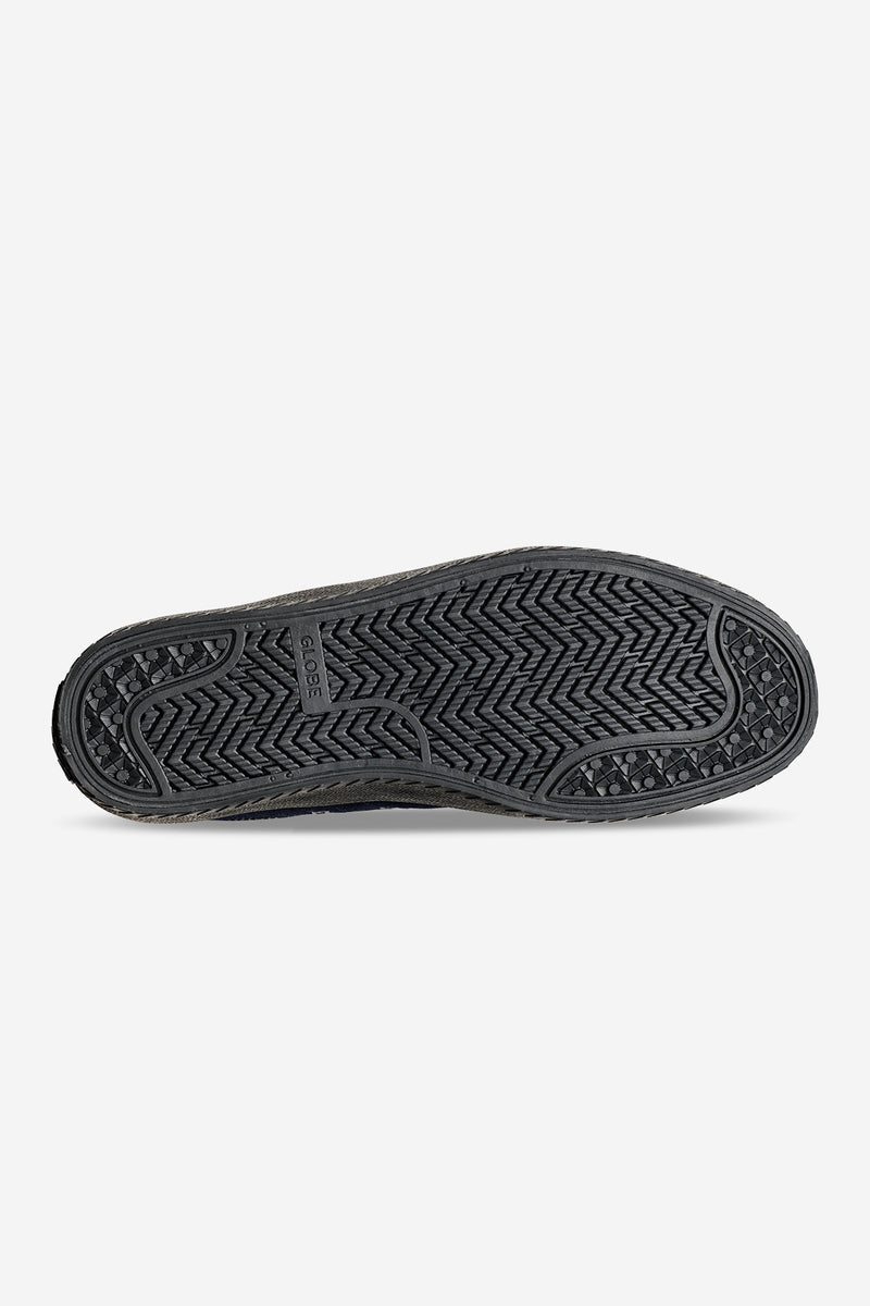 Outsole view of Melbek Denim shoe showing rugged black rubber tread and Globe branding