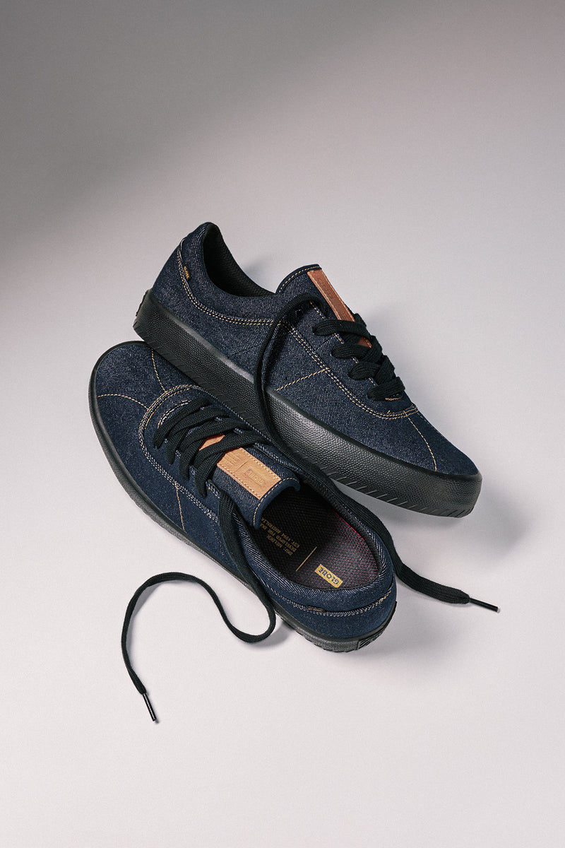 Two Melbek Denim sneakers shown from above with dark denim uppers, black laces, and chunky black soles