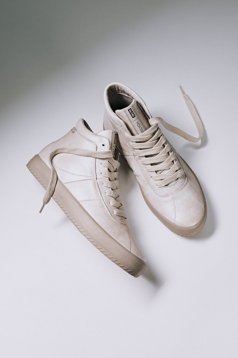 Cream Melbek High high top skate shoes with untied laces shown together.