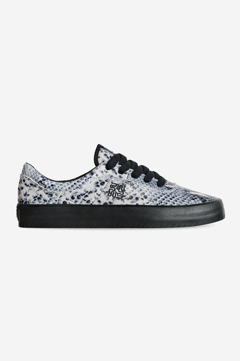 Side profile of Melbek Wasted Talent sneaker in blue snake print suede upper and black sole