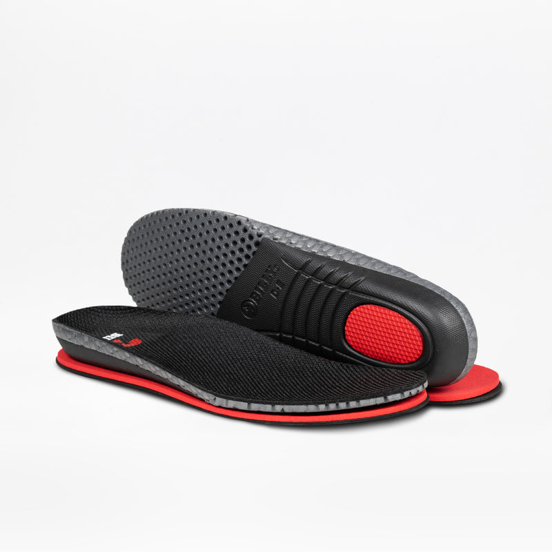 A pair of Men's Black Leather BILLY Comfort Plush insoles by BILLY Footwear is shown: one lies flat showing its textured sensory-friendly upper, while the other reveals a dotted underside and red cushioned heel.