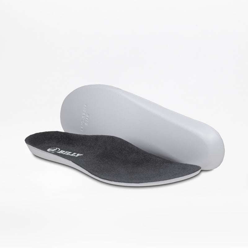 Two charcoal/yellow BILLY Footwear insoles for men's Inclusion Trail shoes are shown on a white background—one lies flat to display the branded top, while the other is propped to reveal its contoured underside.