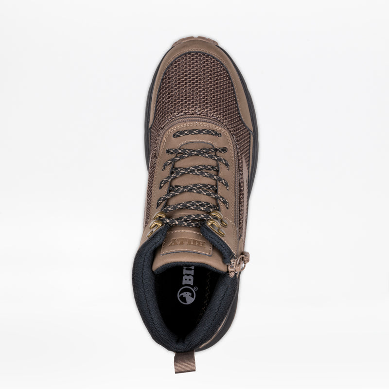 Top view of the Men's Taupe BILLY Inclusion Trail Boot by BILLY Footwear, featuring black and brown laces, gold eyelets, mesh details, a black padded collar, heel pull tab, and easy on/off zipper on a white background.