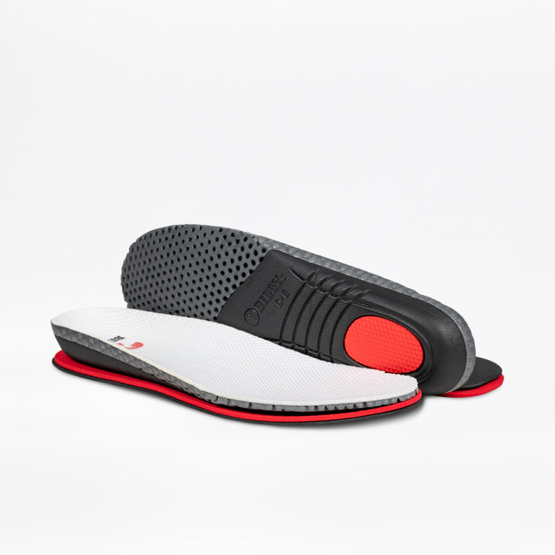 Two BILLY Footwear Men's White/Navy Comfort Court insoles are shown on a white background: one insole lies flat, displaying the white mesh top; the other reveals black and red cushioning layers with textured black soles.