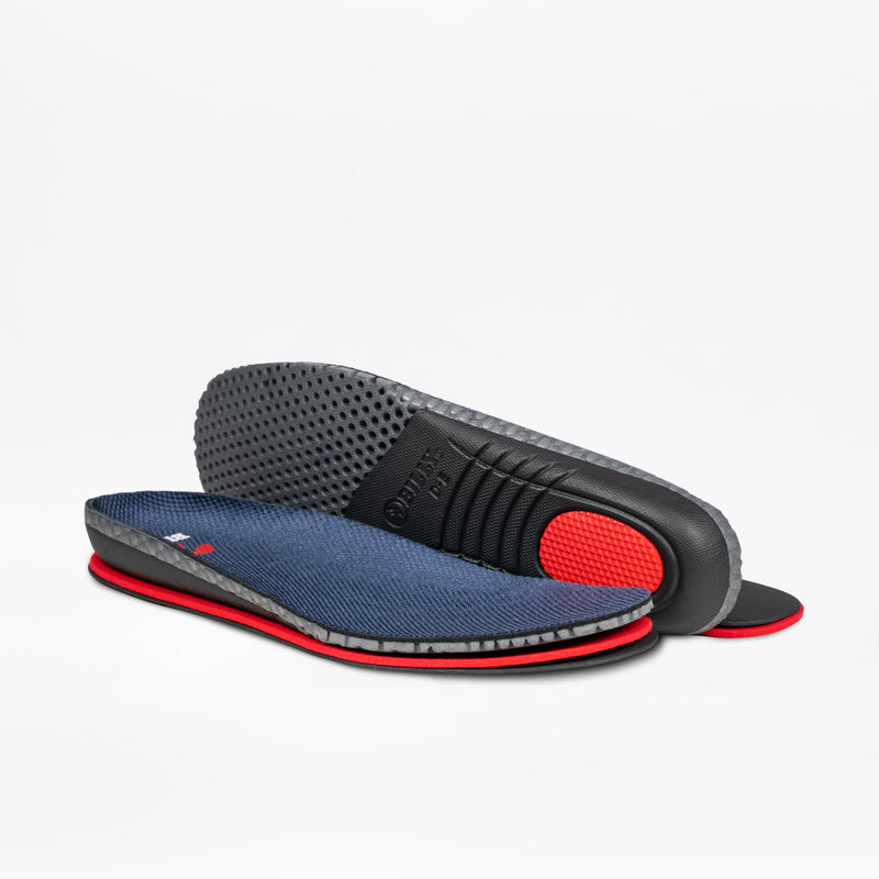A pair of BILLY Footwear Men's White/Navy Limitless 253 insoles with a textured navy top, red edges, and a black underside with a red heel cushion and grip pattern—ideal for sensory friendly shoes—displayed on white background.