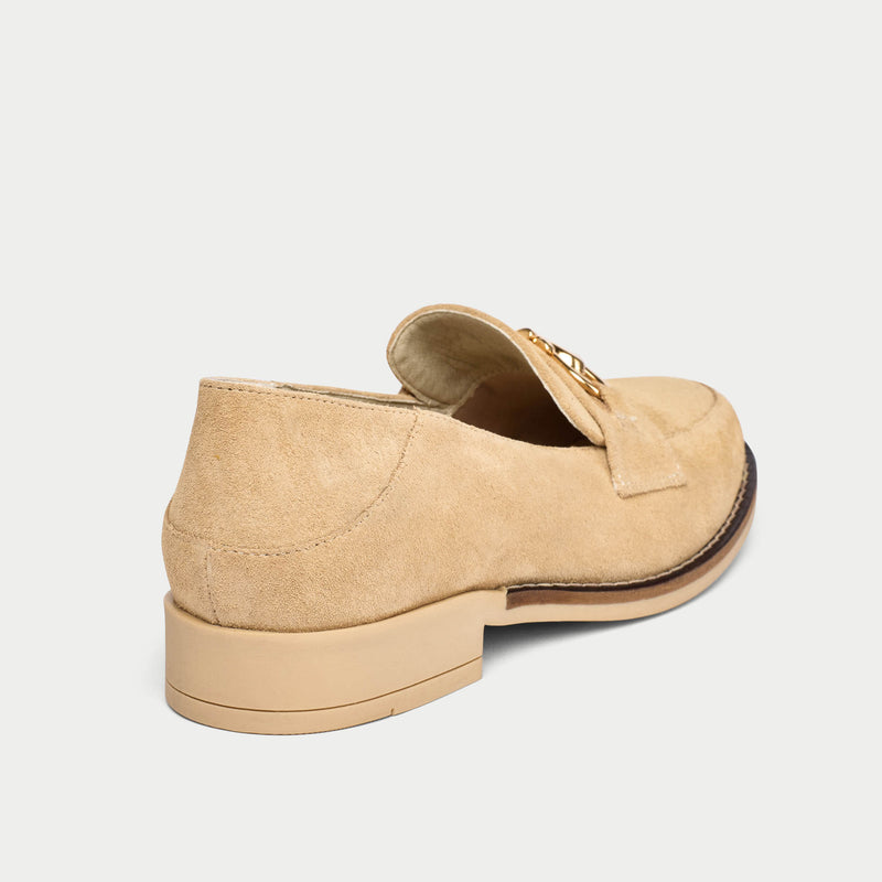 Beige loafer shoe on a light gray background