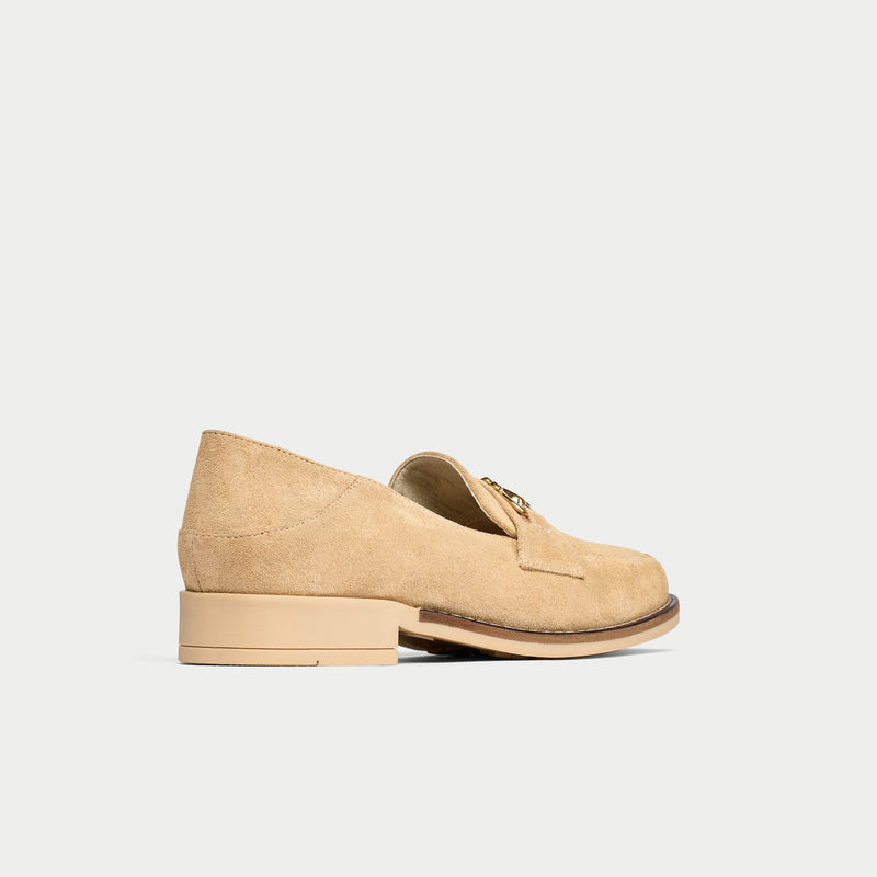 Beige loafer shoe on a light gray background