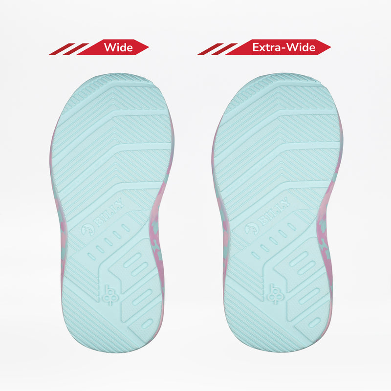 Two light blue shoe soles of the BILLY Footwear Midnight Mermaid BILLY Goat are shown side by side—Wide on the left and Extra-Wide on the right—highlighting kids’ adaptive width options.