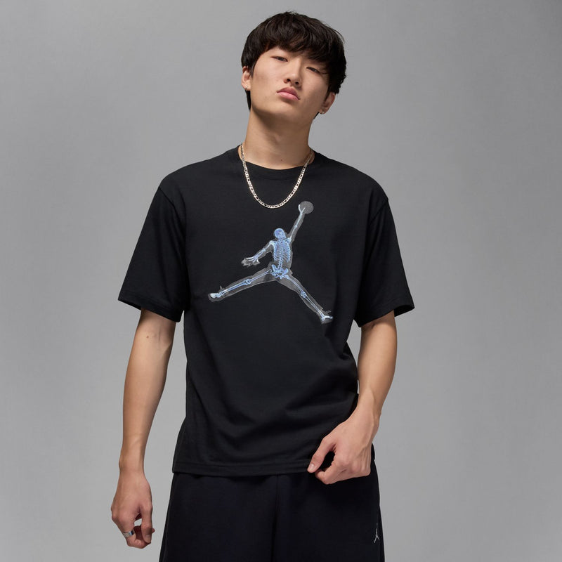 Black men’s crewneck T-shirt with light-blue skeleton basketball print, worn front.