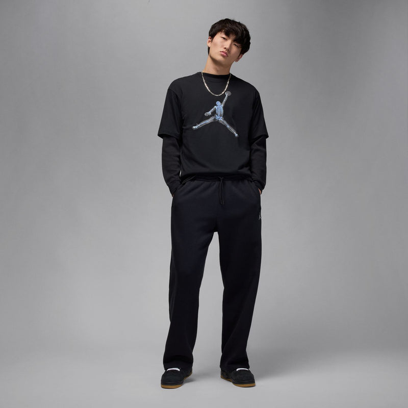 Black crewneck T-shirt with light-blue skeleton basketball print, model standing.