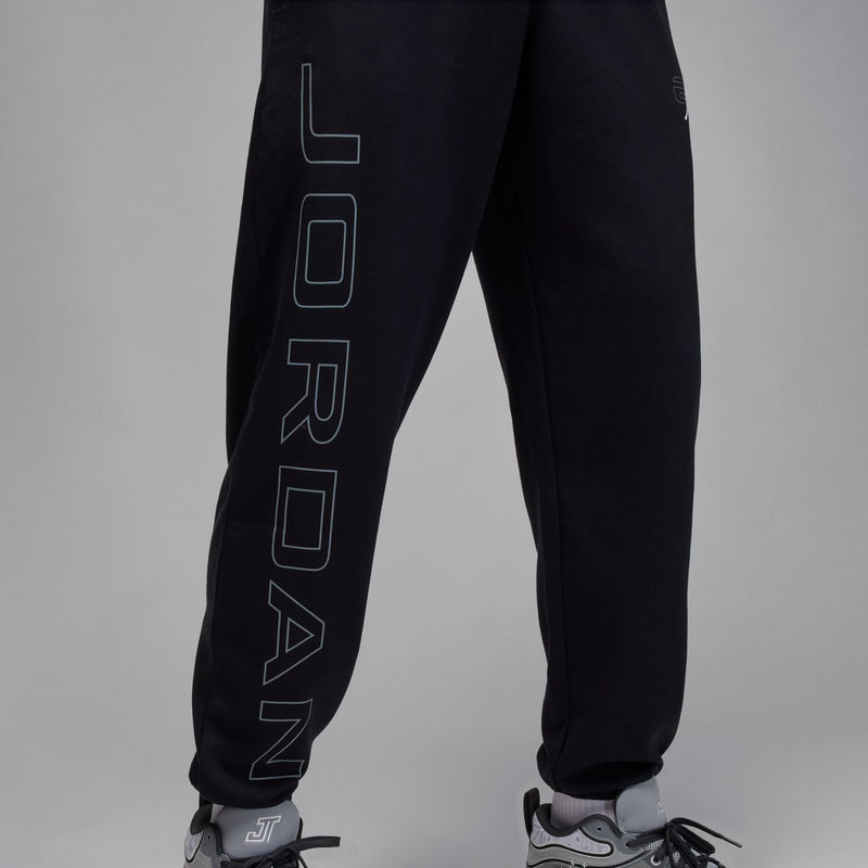 Black sweatpants with large vertical Jordan wordmark graphic on left leg