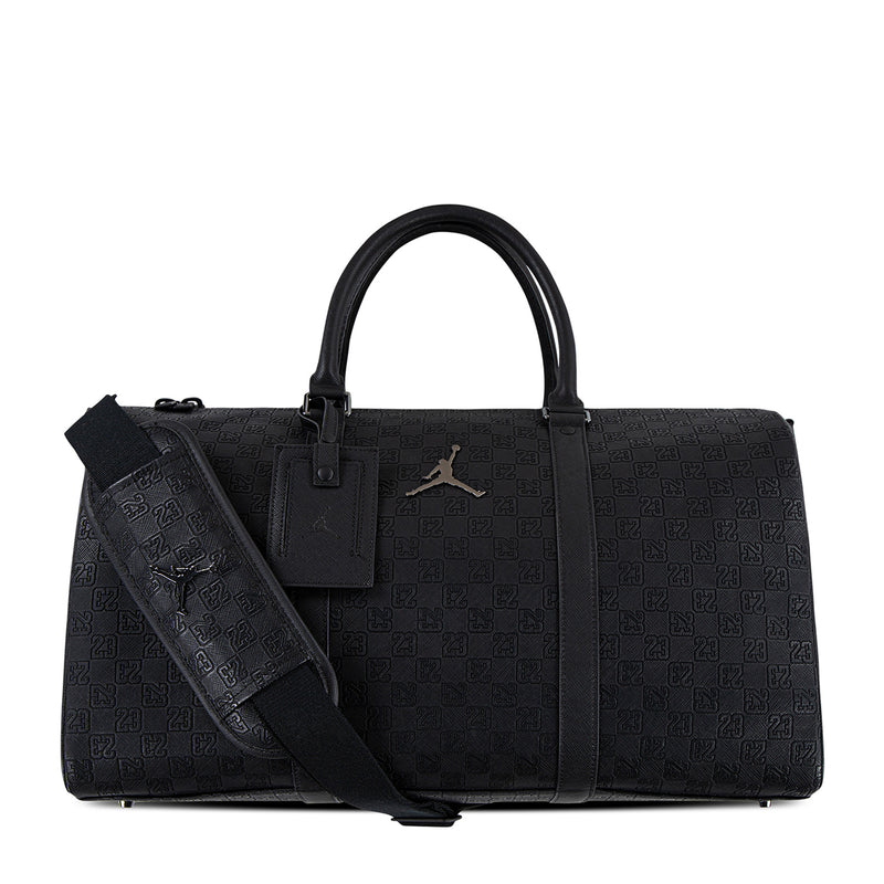 Black monogram duffel bag with top handles, front logo patch, and shoulder strap