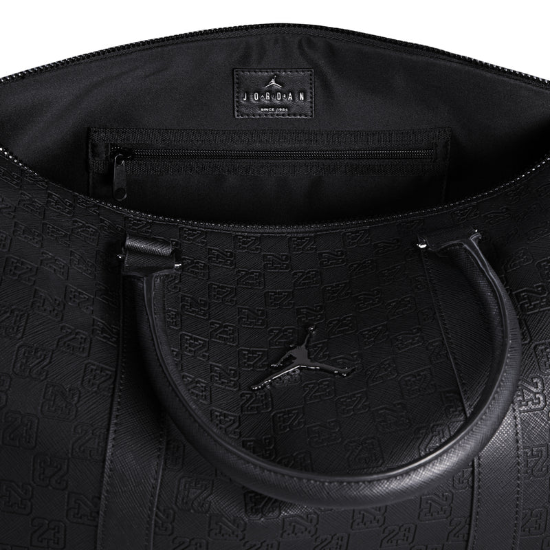 Black monogram duffel bag interior pocket with zipper, shown open