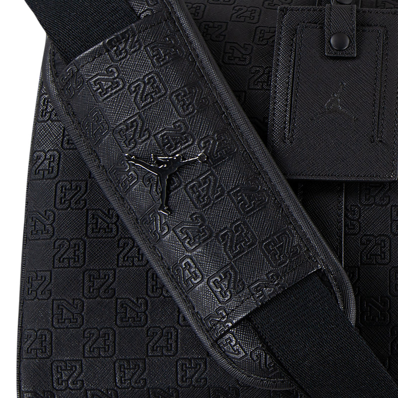 Black monogram duffel bag with padded shoulder strap and logo print