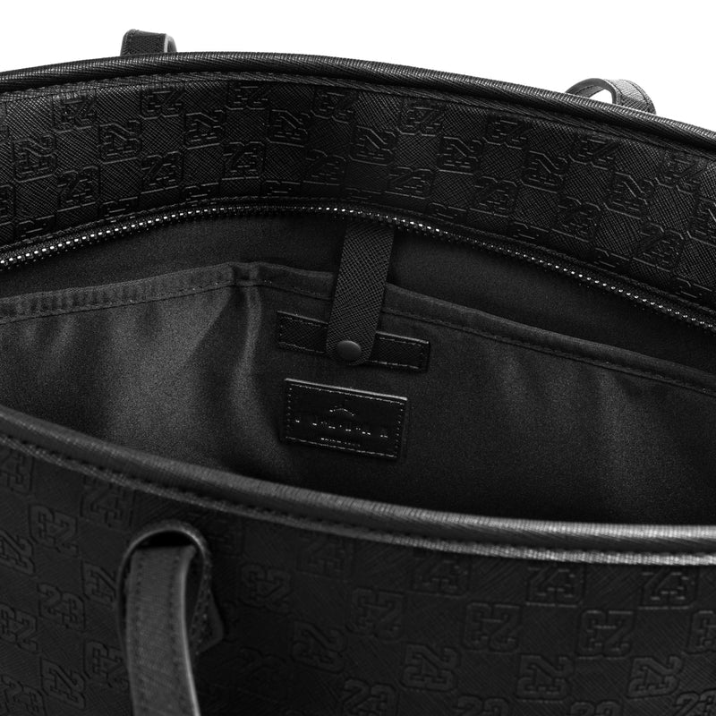 Black tote bag interior with zipper top, hanging logo tag, and pocket