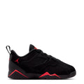 Kids black athletic sneakers with red trim, lace-up front and Jordan logo on side