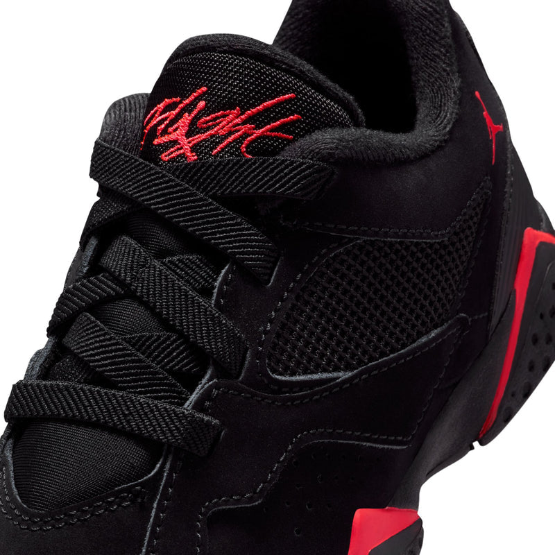Kids black sneaker upper close-up with red Nike logo and stitched lace panel