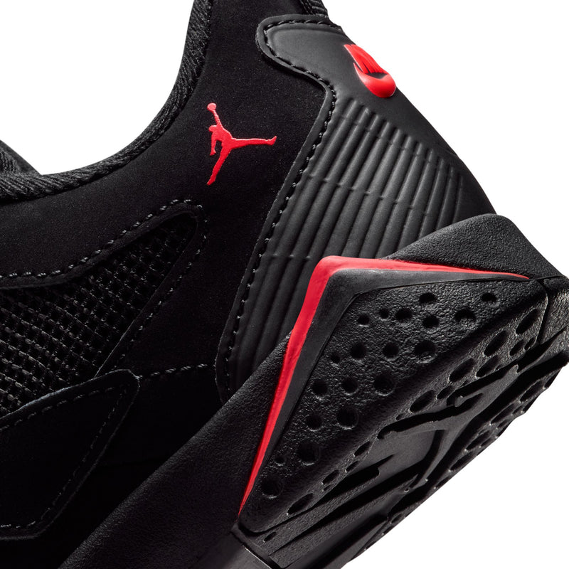 Kids black sneaker side close-up with red Jumpman, textured outsole and ridged panel