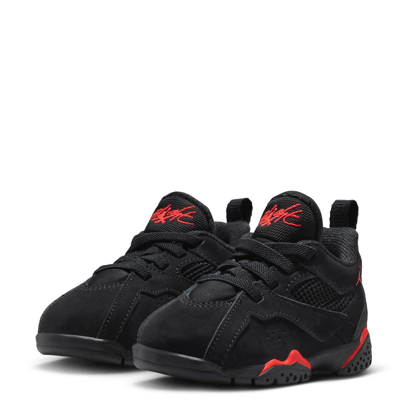 Pair of kids black sneakers with red logo on tongue and lace-up design