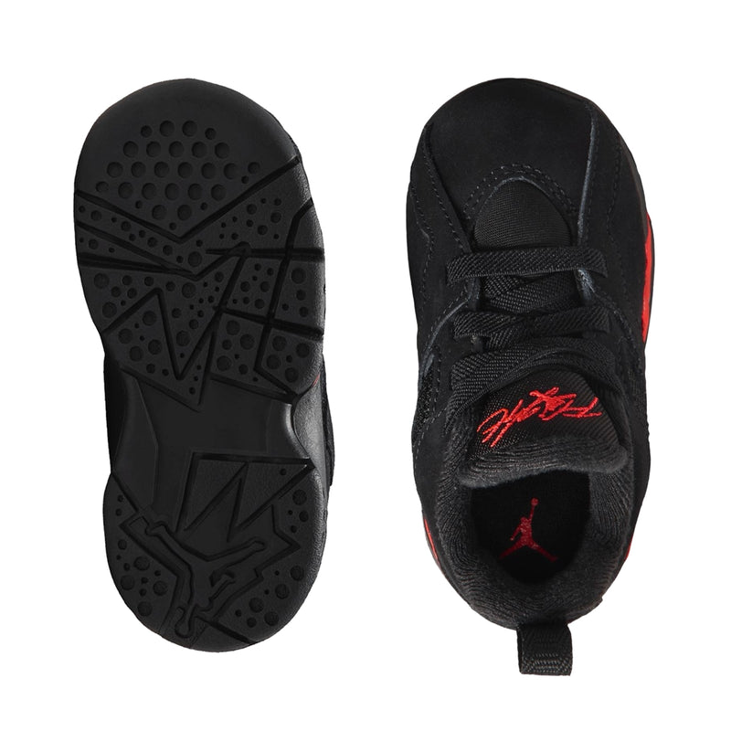 Kids black sneakers, side and outsole view, red heel accent and treaded sole
