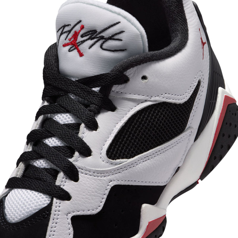 White and black youth sneaker with red Jumpman logo on tongue and black lace-up