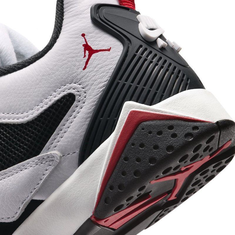 Youth sneaker side and sole detail with red Jumpman logo and black traction tread