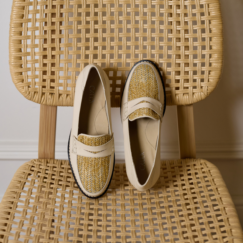 Pair of woven shoes on a wicker chair