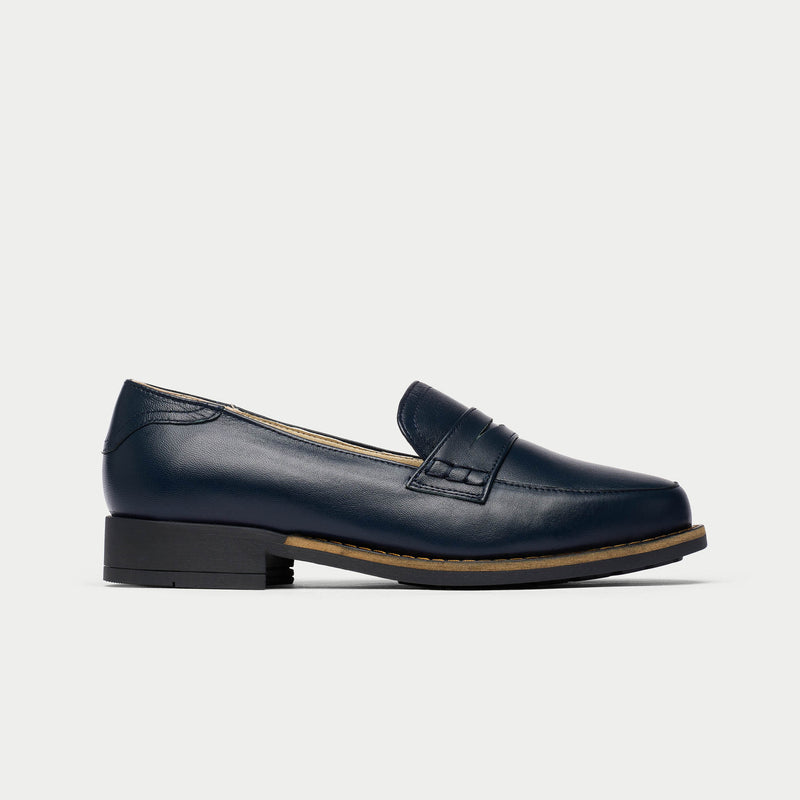 Navy blue loafer shoe on a light gray background