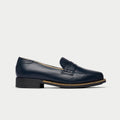 Navy blue loafer shoe on a light gray background