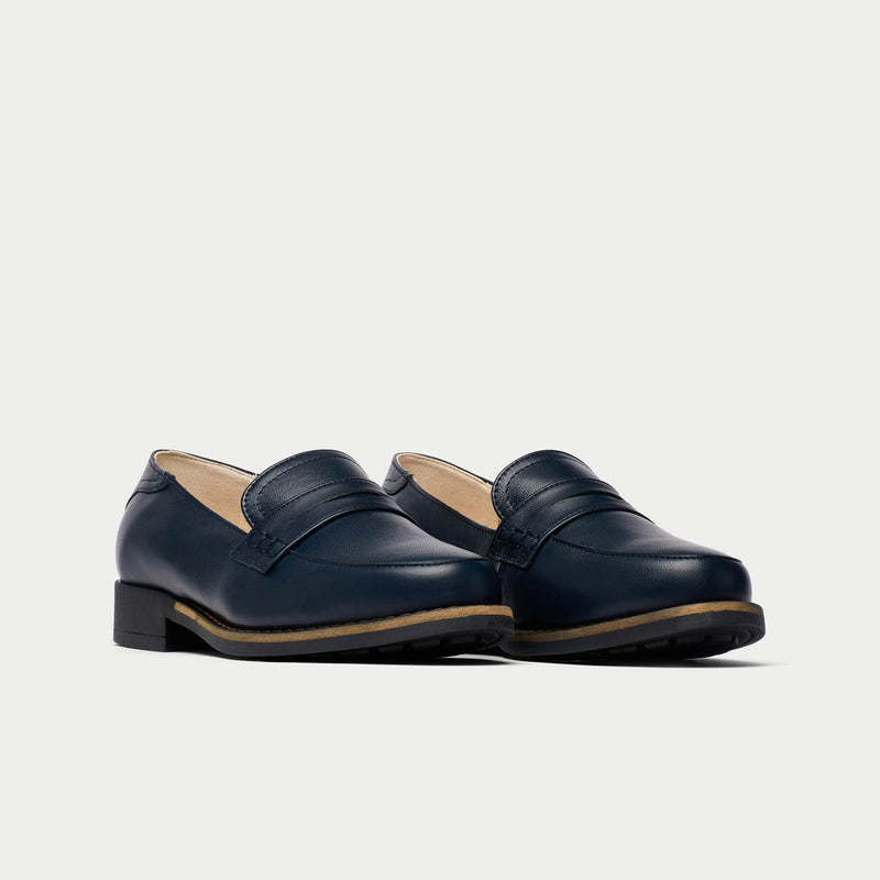 Pair of navy blue loafers on a light gray background