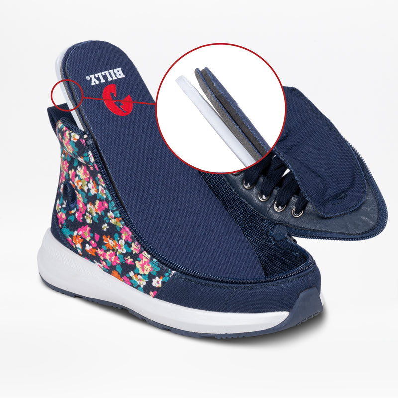 The Navy Floral BILLY Goat Classic High by BILLY Footwear is a kids’ adaptive shoe with a white sole and floral pattern, featuring a removable tongue shown in close-up to highlight its layered design for easy orthotic use.