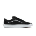 Men's black low-top sneakers with white floral side embroidery and white rubber sole
