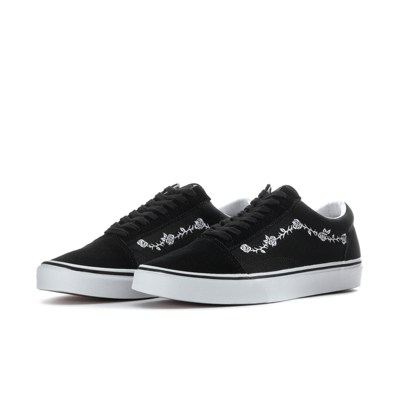 Pair of men's black low-top sneakers with white floral embroidery and white rubber soles